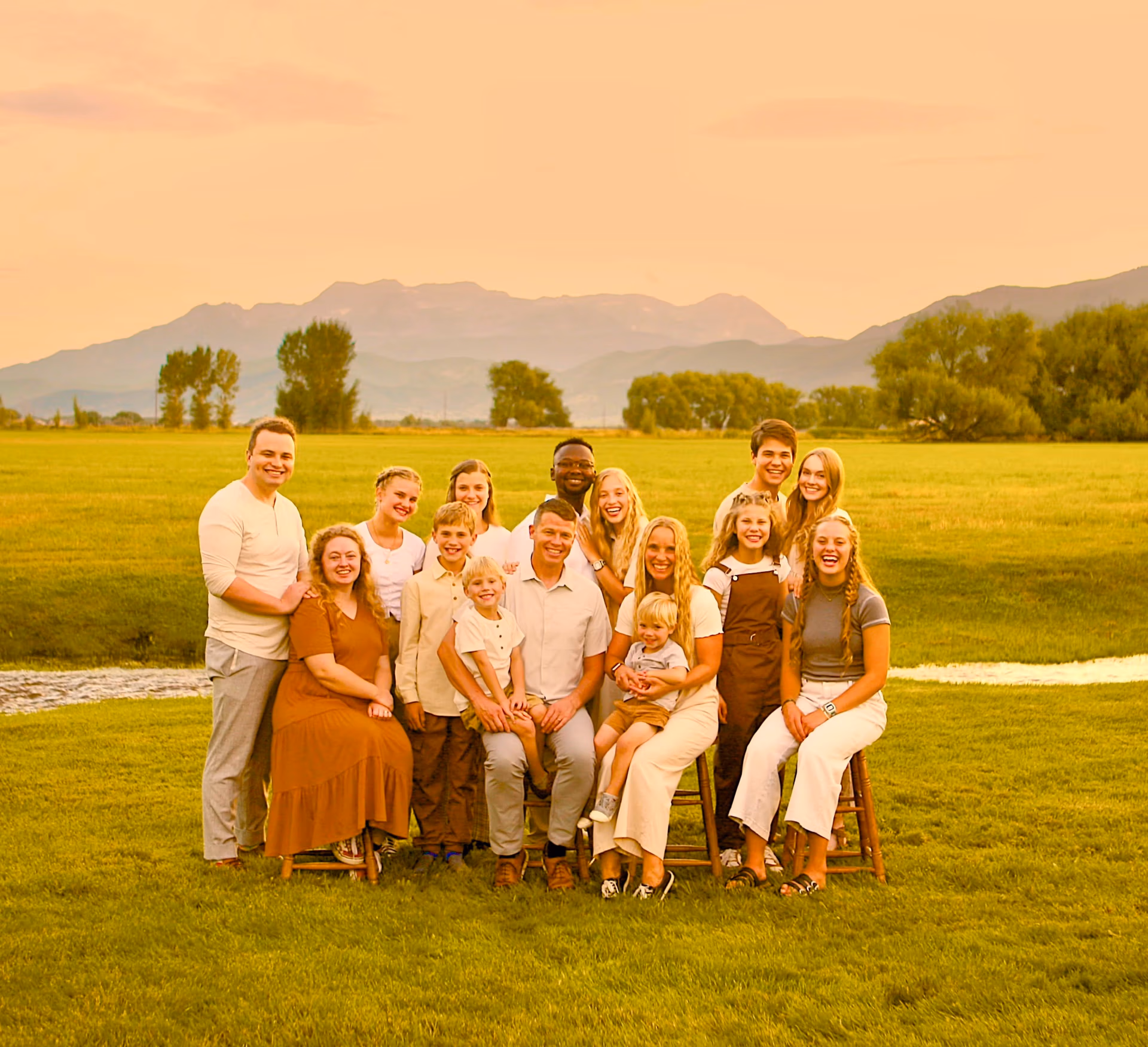 Family portrait of Jared Rigby with his wife and children in a scenic outdoor setting, symbolizing support and sacrifice in public service.